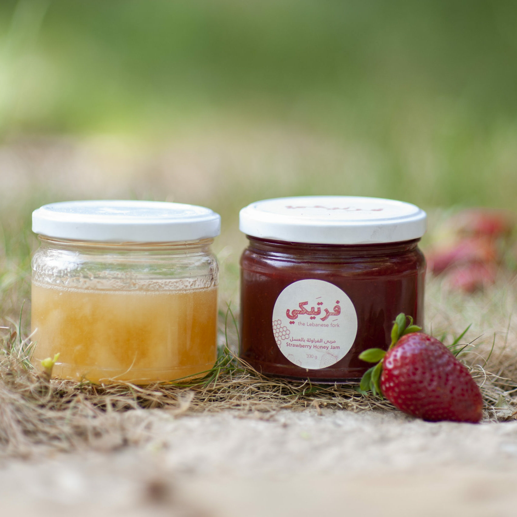 Strawberry honey jam with honey jar